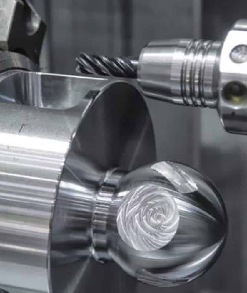 cutter operates on a metal ball, illustrating the technology used in KINEX BEARINGS' machinery division.