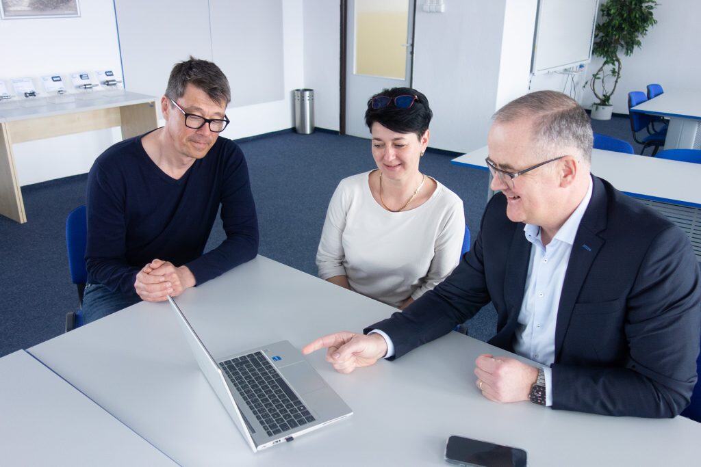 Friendly professional woman in a job interview or career discussion in a modern office setting.